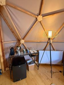 a table and a lamp in a tent at Dôme Bel'Etoile in Bellencombre
