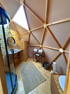 an attic bathroom with a large window and a mirror at Dôme Bel'Etoile in Bellencombre