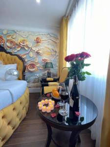 a hotel room with a table with wine glasses and flowers at Diamond Hotel CoLinh in Long Biên