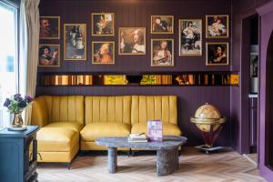a living room with a yellow couch and a table at The Florentine Waterfront Hotel in Florence