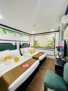 a hotel room with two beds and a television at Diamond Hotel CoLinh in Long Biên +105 photos