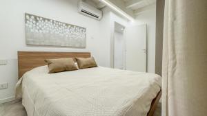 a bedroom with a large bed with white sheets at Cascina Pizzo in San Martino Olearo