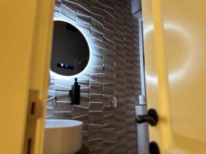 a bathroom with a white sink and a mirror at Mandaraggio Stays in Victoria +23 photos
