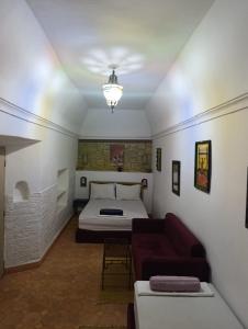 a living room with a bed and a couch at Dar Chamss in Taroudant