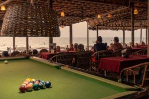 a pool table in a restaurant on the beach at Blue Corner Beach Huts & Restaurant in Benaulim