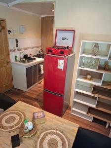 a kitchen with a red refrigerator and a table at My Refugio Wet Wet in Puerto Montt