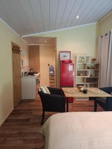 a room with a kitchen and a table and a refrigerator at My Refugio Wet Wet in Puerto Montt