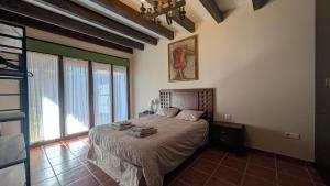 a bedroom with a bed and a large window at Rioja en calma in Villalobar de Rioja