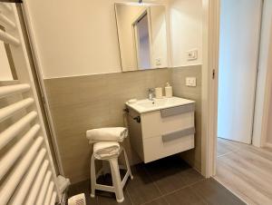 a small bathroom with a sink and a stool at Garba Stop in Rome +11 photos
