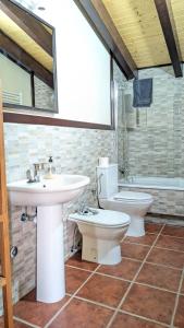 a bathroom with a sink and a toilet and a tub at Rioja en calma in Villalobar de Rioja +19 photos