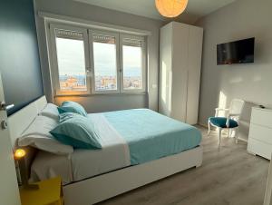 a bedroom with a bed and two windows and a desk at Garba Stop in Rome