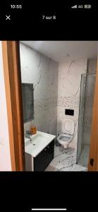 a bathroom with a sink and a toilet at Sweet homme in El Aouina Station