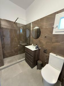 a bathroom with a toilet and a sink and a shower at Limassol center Soul in Limassol +10 photos