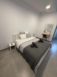 a bedroom with a large bed and a desk at Limassol center Soul in Limassol