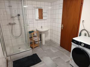 a bathroom with a shower and a sink and a toilet at maison Le Wetz in Sainte-Marie-Kerque