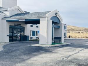 a building with a parking lot in front of it at AmericInn by Wyndham Rawlins in Rawlins