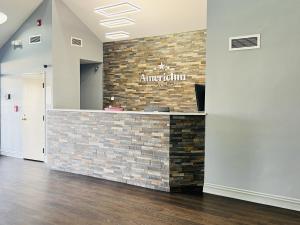 a lobby of an amazonazon sign on a brick wall at AmericInn by Wyndham Rawlins in Rawlins