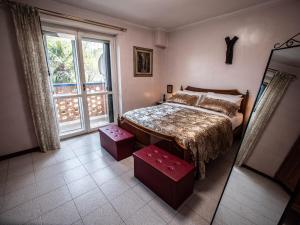 a bedroom with a bed and a large window at Frank & Giuly House in Rivoli