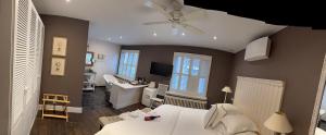 a bedroom with a bed and a desk in it at La Luna Guesthouse in Bruges