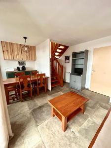 a living room with a table and a kitchen at Chalet d'Estive in Cauterets +1 photo