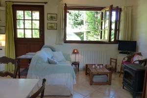 a living room with a couch and a table at La Flore De Lys in Saint-Jouin-Bruneval