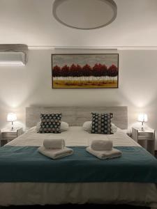 a bedroom with a large bed with two pillows on it at Resplendor Hotel in Viña del Mar +17 photos