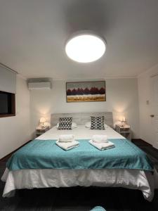 a bedroom with a large bed with two pillows at Resplendor Hotel in Viña del Mar