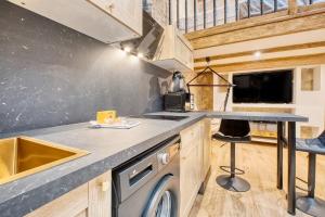 a kitchen with a counter and a sink and a stove at La bulle étoilée in Périgueux +14 photos