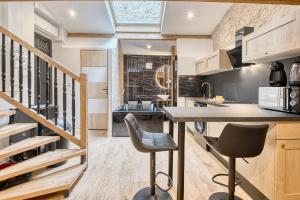 a kitchen with a table and chairs and a staircase at La bulle étoilée in Périgueux
