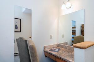 a bathroom with a vanity and a mirror at Bear Creek Lodge 209C in Telluride