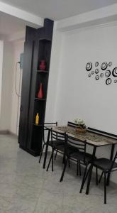 a room with a table and chairs and a shelf at Alojamiento Mililu in Colón +5 photos