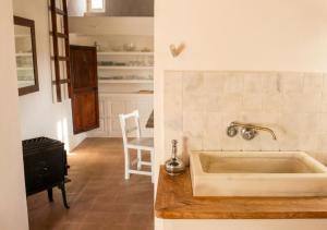 a kitchen with a sink and a kitchen with a table at Can Toni Platera in Sant Francesc Xavier +29 photos