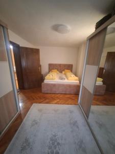 a bedroom with a bed with yellow pillows at Apartman - TAHRIC in Bihać