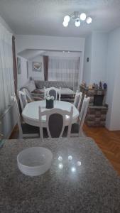 a kitchen and dining room with a table and chairs at Apartman - TAHRIC in Bihać