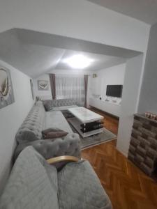 a living room with a couch and a table at Apartman - TAHRIC in Bihać