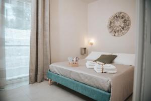 a bedroom with a bed with towels on it at Trullo Alisia - TrulloExperience in Putignano