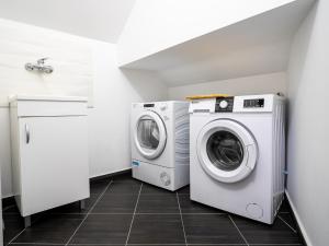 two washing machines and a washer and dryer in a laundry room at B&B Il Trecciolino in Palmi