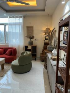 a living room with a couch and a chair at Simbas Den by Abodeandco in Dehradun