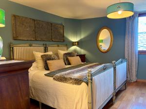 a bedroom with a bed and a mirror at Maison Jacquemin in Saint-Pierre