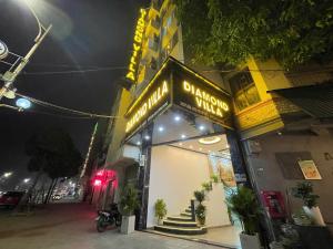a building with a sign for a pharmacy on a street at Diamond Hotel CoLinh in Long Biên