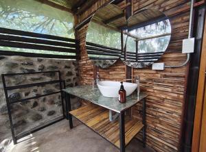 a bathroom with a sink in a wooden wall at Izotal Bioluxury Hotel in Taminango +48 photos