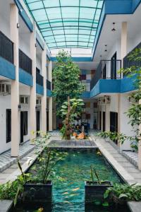 a pool in the middle of a building at De Azka Style Syariah in Malang