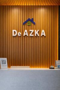 a wooden wall with a deazza sign on it at De Azka Style Syariah in Malang