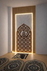 an entrance to a room with a door with a rug at De Azka Style Syariah in Malang +3 photos