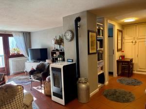 a living room with a room with a heater at Maison Jacquemin in Saint-Pierre