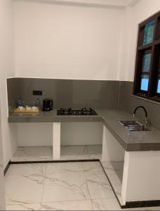a kitchen with a counter top and a sink at Shelo Transit Hotel in Katunayaka