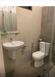 a bathroom with a toilet and a sink at Shelo Transit Hotel in Katunayaka