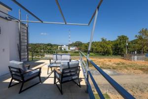 a group of chairs and a table on a patio at Sunset Villas in Crawfish Rock