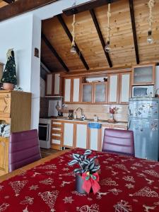 a kitchen with a table with a christmas bow on it at The Mountain House Doris in Kruševo