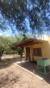 a small building with a green bench in front of it at apartamento VINTAGE LU in Merlo